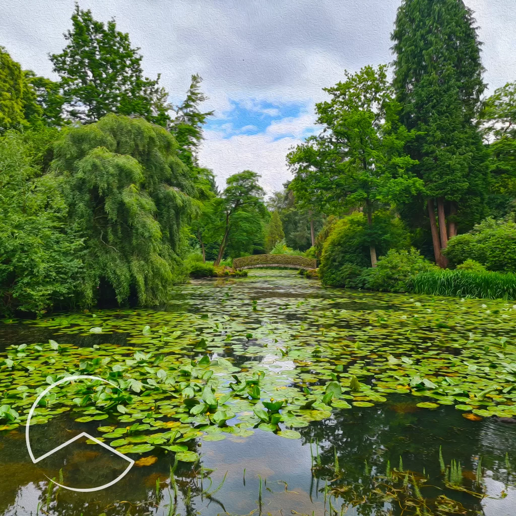 Artwork for Verdancy by Adventsong. Stylised woodland scene with lots of vibrant green trees, with a river running through the middle covered in lily pads and a rustic bridge running over it.