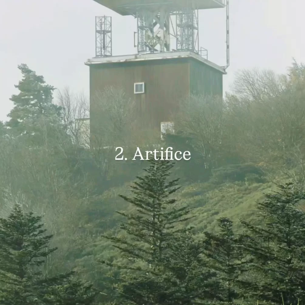 A weather station in a misty forest. The words 2. Artifice and Photo by Louis Gaudiau on it